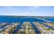 Scenic aerial view of a waterfront community with homes lining canals leading to a large bay at 5265 Neville Ter, Port Charlotte, FL 33981