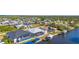 Aerial view of homes along the canal featuring screened-in pools, boat docks, and beautiful waterfront access at 5265 Neville Ter, Port Charlotte, FL 33981