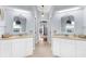 Dual vanities with large decorative mirrors create a luxurious bathroom at 5265 Neville Ter, Port Charlotte, FL 33981