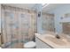 Bright bathroom featuring a shower with coastal-themed shower curtain and a vanity with sink at 5265 Neville Ter, Port Charlotte, FL 33981