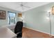 Bright bedroom features hardwood floors, a large window with curtains, and a functional desk at 5265 Neville Ter, Port Charlotte, FL 33981
