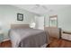 Comfortable bedroom features wood floors, a ceiling fan, and a neutral color palette at 5265 Neville Ter, Port Charlotte, FL 33981