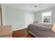 Cozy bedroom with hardwood floors, neutral color scheme, and double closet at 5265 Neville Ter, Port Charlotte, FL 33981