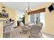 Cozy breakfast nook with a glass table and wicker chairs, illuminated by a chandelier at 5265 Neville Ter, Port Charlotte, FL 33981