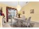 Formal dining area with chandelier lighting, large windows and bright interior paint at 5265 Neville Ter, Port Charlotte, FL 33981