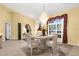Bright formal dining room with chandelier, tile flooring, and natural light at 5265 Neville Ter, Port Charlotte, FL 33981
