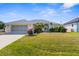Charming single-Gathering home boasting a well-manicured lawn, screened garage and tasteful landscaping at 5265 Neville Ter, Port Charlotte, FL 33981
