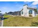 Exterior of home featuring a screened lanai, well-maintained lawn, and canal-front access at 5265 Neville Ter, Port Charlotte, FL 33981