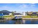 Waterfront home with a private boat lift and screened-in lanai, perfect for enjoying the coastal lifestyle at 5265 Neville Ter, Port Charlotte, FL 33981