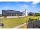 Exterior view of a canal-front home featuring a large screened-in lanai and grassy backyard at 5265 Neville Ter, Port Charlotte, FL 33981