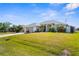 Well-manicured front lawn showcasing a charming single-Gathering home with lovely landscaping at 5265 Neville Ter, Port Charlotte, FL 33981