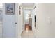 Hallway with neutral paint and tile, connecting the living space to the bathroom at 5265 Neville Ter, Port Charlotte, FL 33981