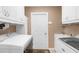 Laundry room with white cabinets, sink, and washer and dryer at 5265 Neville Ter, Port Charlotte, FL 33981