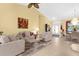 Inviting living room with vaulted ceilings, a ceiling fan, and an abundance of natural light at 5265 Neville Ter, Port Charlotte, FL 33981