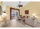 Cozy living room featuring tile floors, comfortable couches, and abundant natural light at 5265 Neville Ter, Port Charlotte, FL 33981