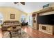 Comfortable living room featuring hardwood floors, vaulted ceiling, built-in shelving, and sliding glass door to outdoor area at 5265 Neville Ter, Port Charlotte, FL 33981