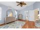 Spacious main bedroom with wood floors, fan, light paint, and ensuite bathroom at 5265 Neville Ter, Port Charlotte, FL 33981