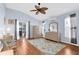 Cozy main bedroom with ceiling fan, wood floors, and private access to the lanai at 5265 Neville Ter, Port Charlotte, FL 33981
