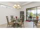 Dining area with outdoor access and modern chandelier at 5585 Semolino St, Nokomis, FL 34275