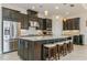 A kitchen with stainless steel appliances, dark cabinets and granite countertops at 5585 Semolino St, Nokomis, FL 34275