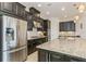 Modern kitchen with stainless steel appliances and granite countertops at 5585 Semolino St, Nokomis, FL 34275