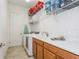 Functional laundry room featuring a sink, storage cabinets, and modern washer and dryer at 5585 Semolino St, Nokomis, FL 34275