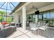 Screened patio with outdoor dining, fire pit, and comfortable lounge furniture at 5585 Semolino St, Nokomis, FL 34275