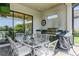 Outdoor patio with dining table, barbecue, and view of the backyard at 5585 Semolino St, Nokomis, FL 34275
