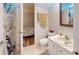 Bathroom featuring decorative shower curtain, vanity with sink, and wooden floor visible in next room at 5619 Bayshore Rd # 421, Palmetto, FL 34221