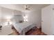 Bright bedroom featuring wood floors, ceiling fan, and seashell-patterned bedding on a comfortable bed at 5619 Bayshore Rd # 421, Palmetto, FL 34221