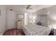 Comfortable bedroom with ceiling fan, dresser, mirror, closet, and decorative seashell bedding at 5619 Bayshore Rd # 421, Palmetto, FL 34221