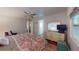 Bedroom with wood floors, dresser, mirror, and windows, creating a cozy and inviting space at 5619 Bayshore Rd # 421, Palmetto, FL 34221