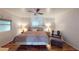 Bright bedroom with wood floors, ceiling fan, and comfortable seating area by the window at 5619 Bayshore Rd # 421, Palmetto, FL 34221