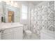 Bright bathroom featuring a vanity, toilet, decorative shower curtain, and vanity lights at 5632 Long Shore Loop, Sarasota, FL 34238