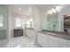 Elegant bathroom featuring double sinks, quartz countertops, and a walk-in shower at 5632 Long Shore Loop, Sarasota, FL 34238