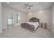 Spacious bedroom with plush carpet, tray ceiling, and large mirror at 5632 Long Shore Loop, Sarasota, FL 34238