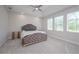 Bright bedroom with tray ceiling, carpet floors, tufted bed and lots of natural light at 5632 Long Shore Loop, Sarasota, FL 34238