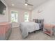 Cozy bedroom featuring soft carpet, dresser and windows that offer natural light at 5632 Long Shore Loop, Sarasota, FL 34238