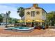 Quaint cafe exterior with outdoor seating, umbrellas, and charming architecture at 5632 Long Shore Loop, Sarasota, FL 34238
