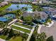 Aerial view of clubhouse, bocce ball court, tennis courts and manicured landscaping in a serene community at 5632 Long Shore Loop, Sarasota, FL 34238