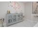 Elegant dining area features grey buffet with mirrored doors and chic floral wall art at 5632 Long Shore Loop, Sarasota, FL 34238