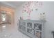 Entryway features a grey buffet with mirrored doors and chic floral wall art at 5632 Long Shore Loop, Sarasota, FL 34238