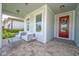 Relaxing front porch seating area with views of the entryway and neighborhood at 5632 Long Shore Loop, Sarasota, FL 34238
