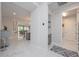 Hallway featuring a view of the living room and access to a bathroom at 5632 Long Shore Loop, Sarasota, FL 34238