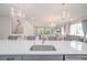 Kitchen sink and island overlooking the spacious living area and backyard, perfect for entertaining at 5632 Long Shore Loop, Sarasota, FL 34238