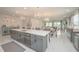 Open kitchen featuring a spacious island, stainless steel appliances, and stylish decor at 5632 Long Shore Loop, Sarasota, FL 34238