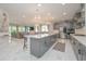 Open-concept kitchen with a large island, stainless steel appliances, and modern lighting at 5632 Long Shore Loop, Sarasota, FL 34238