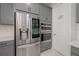 Stainless steel refrigerator and double ovens in the kitchen, with adjacent pantry at 5632 Long Shore Loop, Sarasota, FL 34238
