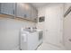 Laundry room with white front load washer and dryer at 5632 Long Shore Loop, Sarasota, FL 34238