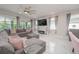 Cozy living room with modern decor, recessed lighting, and large sliding glass doors at 5632 Long Shore Loop, Sarasota, FL 34238